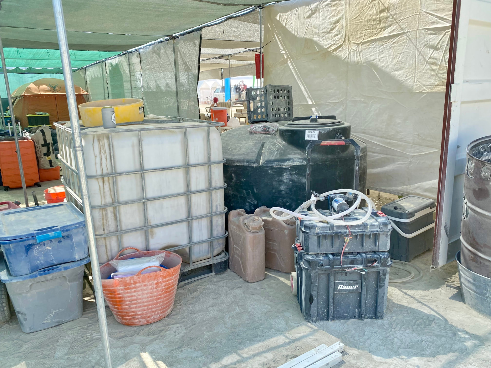 Water tanks and a pump system installed under shade cloth