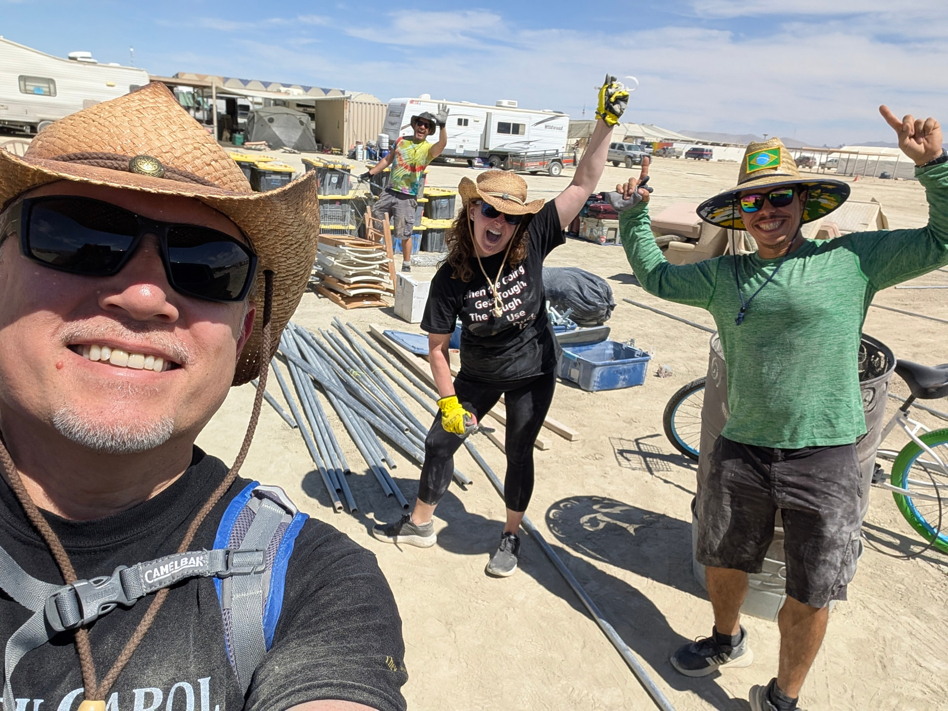 Build crew cheering with tools raised at the finished frame