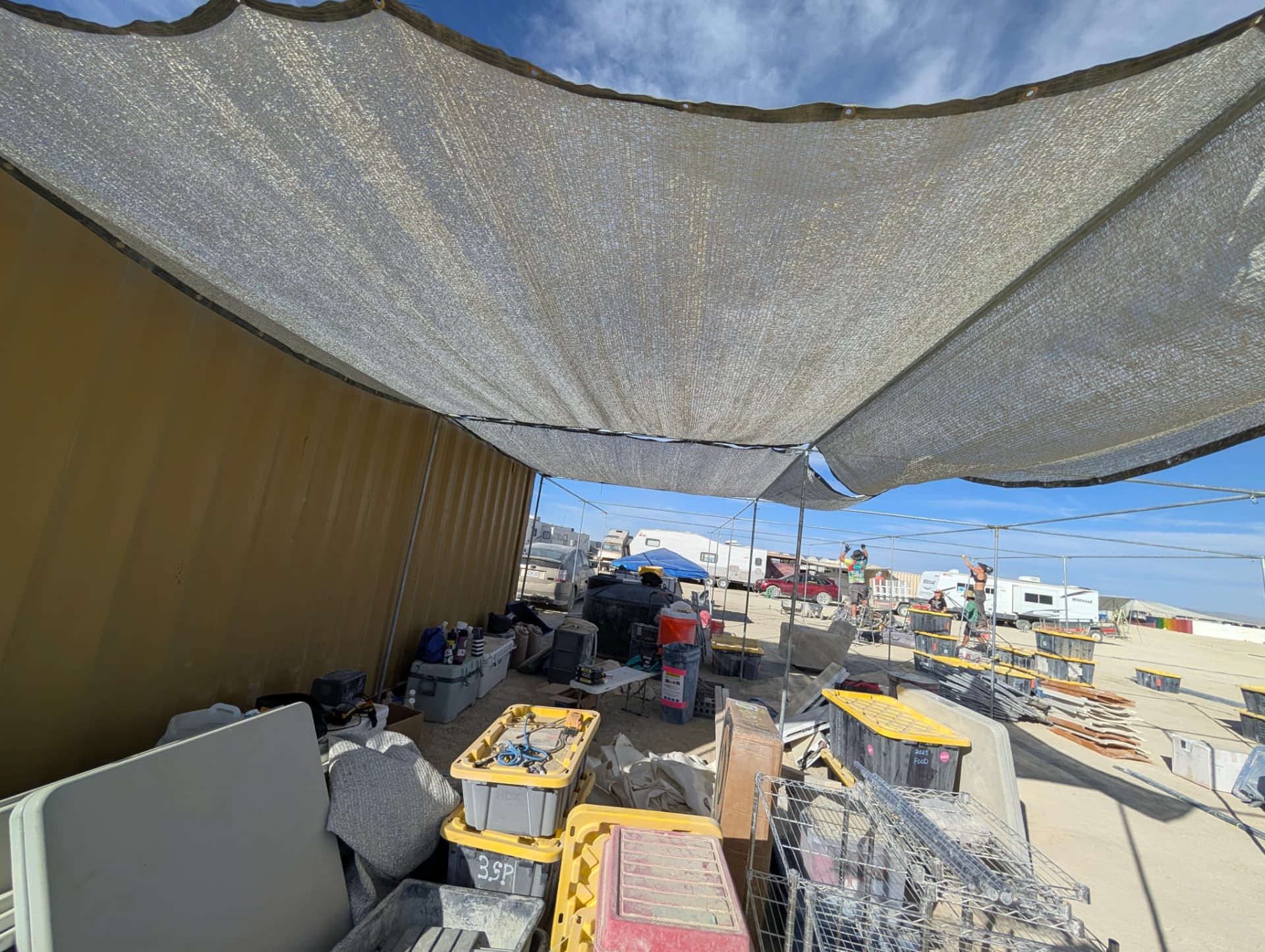 Shade cloth stretched over the Vivarium container and camp gear on the open playa